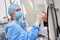 Anesthetist or nurse checks the patient's ventilator monitor during surgery