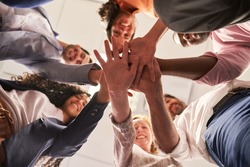 Group of friends as a startup team stacking hands for team spirit and network