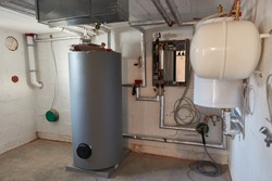 Modernization of boiler room in the basement with boiler and heat pump