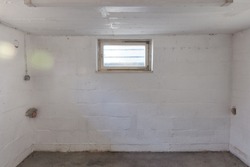 Empty room in the basement with a basement window as a drying room or boiler room