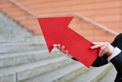 Businesswoman holding ted arrow sign as growth and innovation concept symbol