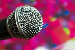 Big silver microphone in concert hall with defocused bokeh lights on background