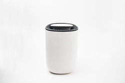 New, portable dehumidifier colect water from air on white background close-up
