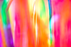 Abstract digital rainbow gradient retro 90s party festival wallpaper of vertical psychedelic multicolored rainbow neon lines with glowing light