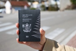 New Zealand passport in hand