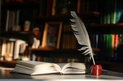 An open book. Next to it is an inkwell with a quill pen. Background - bookshelves illuminated by the sun.