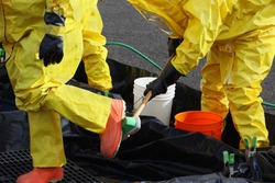 These HAZMAT team members have been wearing protective suits to protect them from hazardous materials during a disaster preparedness drill and have to go through decontamination washes.