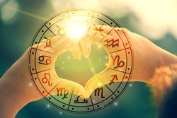 The hands of women and men are the heart shape with the sun light passing through the hands have astrological symbols