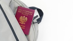 Poland Passport on a grey Travel Bag with white background copy space - Polish