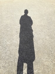 shadow of woman on cement floor