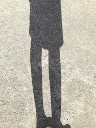 shadow of woman on cement floor