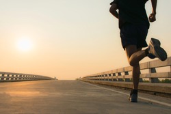 Man running jogging on bridge road. Health activities, Exercise by runner.
