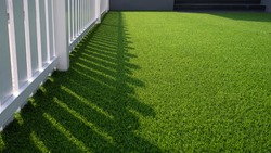 Artificial Grass Turf and white Wooden Picket in Front Yard area of modern House