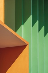 Abstract colorful geometric pattern background, Light and shadow on surface of orange and green shading fin concrete in perspective side view and vertical frame