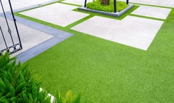 Artificial Turf with Gravel stone pavement decoration and green plant in Home Gardening area