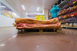 a large mountain of minced pork meat lies on the counter of the store