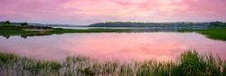 Pastel Pink Sunset on Cape Cod. Peaceful Seascape over Falmouth Marsh Bay with Clouds Reflected on Sea Water. Panoramic Horizontal Coastal Landscape with Space for Text or Design.