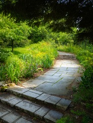 Brick Walkway in Forest Garden. Curved Footpath in the Woods. Nature Trail Trip Image with Space for Text.