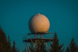 Detail view of a rain radar or meteorological doppler radar for measuring precipitation in early morning hours during sunrise on Pasja Ravan hill in Slovenia