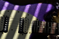 Old Purple Sparkle Electric Guitar in Sunlight