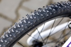 White children's bicycle, close-up on the tire tread. Blurred background, photo taken in natural, soft light