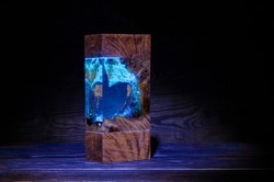 Night lamp with a beautiful wooden texture and blue eboxytic resin