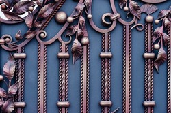 Decorative metal gates of blue and yellow colors with wrought iron elements