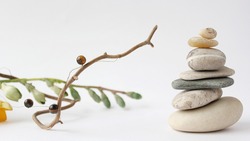 Balance of stones. Stones for spa treatments on a white background. The concept of meditation in the stones is stacked in pyramid.