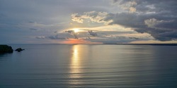 Panoramic view of quiet cove and cape stained in the sunset at Hokkaido