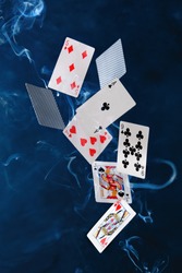 
poker cards and chips fly in the air