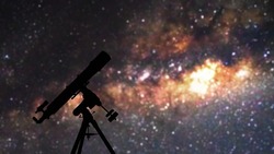 Silhouette of telescope under the starry skies.