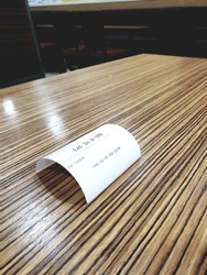arch receipt on lined wooden table.