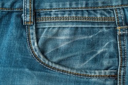 Pocket of blue jeans, old jeans close-up