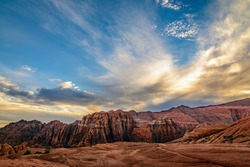 Dramatic clouds cover the sky over the mountains in Snow Canyon state park in St. George, Utah