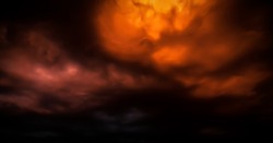 Fantastic concept mystical horror background from another planet from the paranormal world, fantasy style. Dramatic red black orange sky with scary hellish clouds and terrible shadows and fiery light
