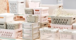Organization of home space, storage and coziness, a lot of plastic household goods, new clean container boxes with a lid for easy storage of things