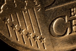 Close-up of a ten cent euro coin. Close-up of ten euro coins on the table. Euro coin with selective focus