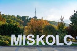 Miskolc text sign in the Park downtown with radio tv tower background