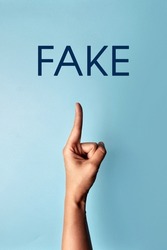 The person points to the word: fake. False information