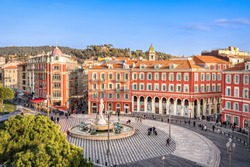 Aerial view of Place Massena square with red buildings  and fountain in Nice, France