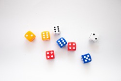 Colourful dice isolated on white. Group of coloured plastic dice.Top view of colourful dices in white background. 