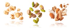 A set with Flying in air fresh raw whole and cracked pistachios, almonds and hazelnut isolated on white background. Concept of Pistachios almonds and hazelnut is torn to pieces close-up.