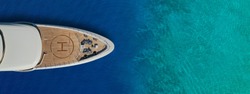 Aerial drone ultra wide panoramic top view photo of large yacht - boat with helicopter landing area anchored in tropical exotic paradise bay with turquoise open sea