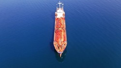 Aerial drone photo of gas carrier tanker boat or LPG (Liquefied Petroleum Gas) tanker anchored near Mediterranean port