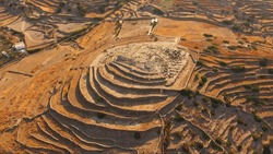 Aerial drone photo of iconic prehistoric settlement of Skarkos, Ios island, Cyclades, Greece
