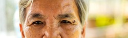 Close up eyebrows and eyes of an old Asian woman.