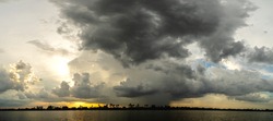 Panorama Dark sky and dramatic black cloud before the rain. rainy storm over the river.
