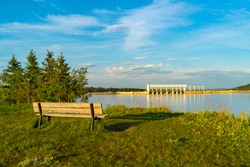 Landscape of a bench overlooking ghost lake and the Ghost Hydroelectric dam west of cochrane alberta, Canada