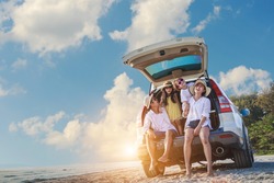 Holiday and travel family concept, Summer vacations . Happy family enjoying road trip with their favorite car. Parents and children are traveling the way to the sea or ocean or river.