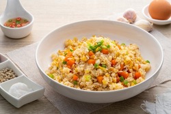 Thai Fried rice with egg and sliced carrot in white plate.Easy cooking food